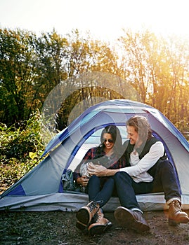 Taking him on his first camping trip. an adventurous couple out camping with their dog.