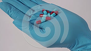Taking or holding medication pills in hand. Capsule pill on white background