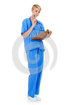 Taking a look at a patients chart. A young female doctor holding a clipboard against a white background.