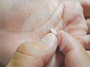 Taking a Medication Pill from a Hand