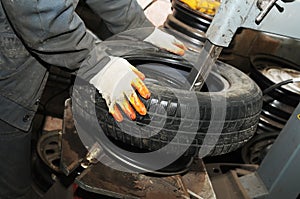 Taking off tyre from car wheel disc