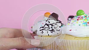 Taking one delicious sweet cup cake while rotating