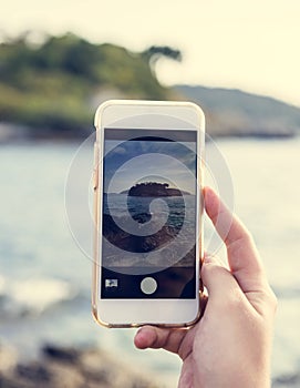 Taking photo of the beach for travel memories