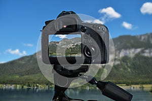 Taking photo of beautiful mountain landscape with camera mounted on tripod