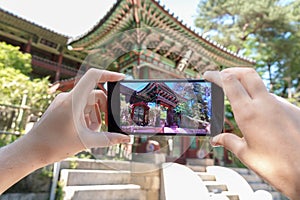 Taking Photo of Korean Architecture with Mobile Phone. Tourism and Digital Technologies