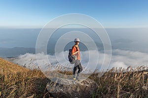 Taking photo on rock on sunset peak, Lantau Island, Hong Kong