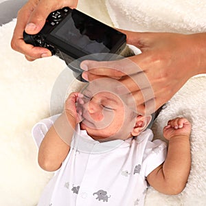Taking photo of sleeping newborn baby boy