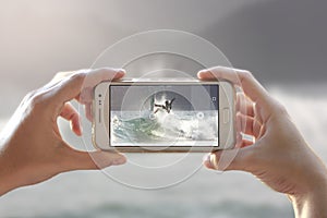 Taking a photo of a surfer on a wave.