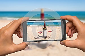 Taking photo of wine and glasses with mobile phone