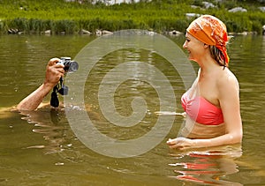Taking photos of smiling woman in water