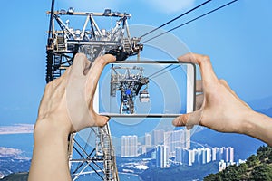 Taking picture of Ngong Ping Cable Car in Hong Kong with smartphone