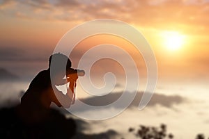 taking pictures a sunset in the mountains