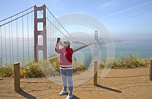 Taking a selfie with the Golden Gate bridge.