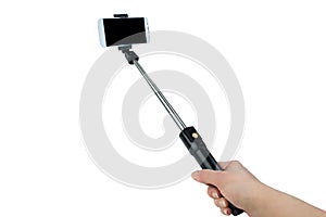 Taking selfie - hand hold monopod with mobile phone.