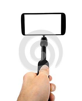 Taking selfie - hand hold monopod with mobile phone