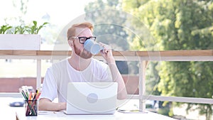 Taking Sip of Hot Coffee, Drinking while Sitting in Outdoor Office, Red Hairs