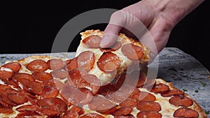 Taking slice of pizza, melted cheese dripping. Frame. Close-up Of People Hands Taking Slices Pizza black background