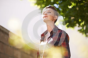 Taking in some fresh air. A cropped shot of a beautful young woman standing in her garden.