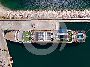 Taking in the stunning aerial view, a massive cruise ship sits docked in the bustling port