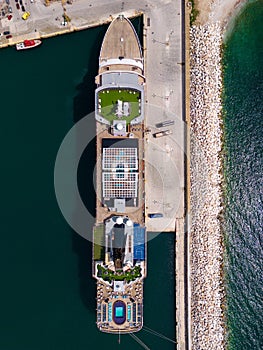 Taking in the stunning aerial view, a massive cruise ship sits docked in the bustling port