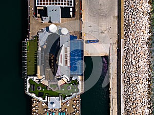 Taking in the stunning aerial view, a massive cruise ship sits docked in the bustling port