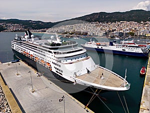 Taking in the stunning aerial view, a massive cruise ship sits docked in the bustling port