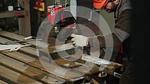 Taking video details of a working hands of blacksmith using hammer to work with piece of metal in the metalwork factory