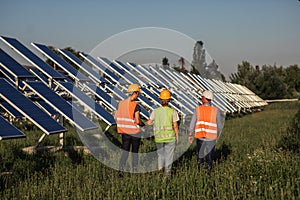 Taking video at photovoltaic solar panels walking through the farm ecological engineer and investor they analysing the