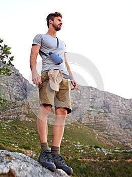 Taking in the views. a handsome young man enjoying the view while hiking.