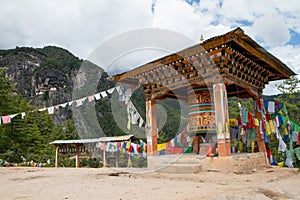 Taktsang Palphug Monastery with prayer wheel photo