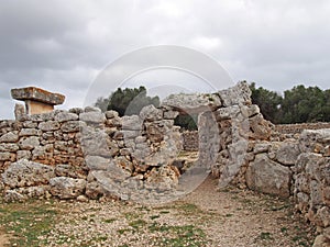 Talaiotic village of Trepuco Minorca Balearic Islands showing the large taula and surrounding stone wall with entrance