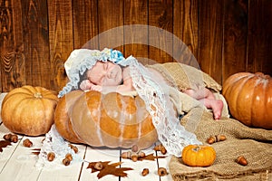 Tale of Cinderella. Little beautiful newborn baby girl in a bonnet sleeping on a pumpkin