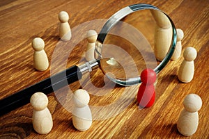 Talent acquisition and management. Magnifying glass and figurines photo