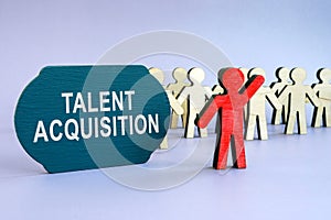 Talent acquisition written on dark plate and wooden figurines.