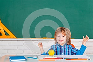 Talented child. Kid is learning in class on background of blackboard. Learning and education concept. Home school for