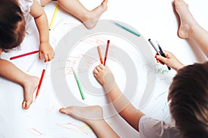 Talented children draw with colored felt-tip pens on white paper, lessons, tasks with children of the different ages