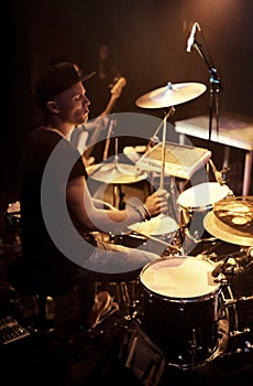 A talented drummer playing drums at a show. This concert was created for the sole purpose of this photo shoot, featuring