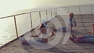 Talented energetic girl dancing twerk in sunset by the sea