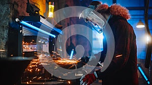 Talented Female Fabricator Uses an Angle Grinder to Polish a Circular Metal Object. The Ring is Gr