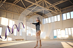 Talented gymnast dancing on floor