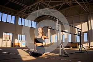 Talented gymnast sitting on the floor