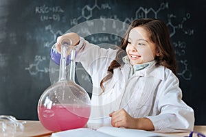 Talented little girl taking part in science experiment in the laboratory photo