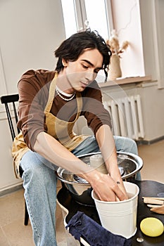 Handsome stylish man creates pottery in