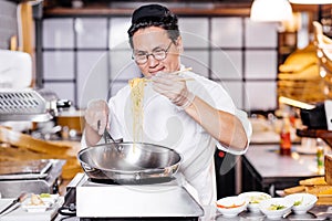 Talented man teaching to prepeare Chinese noodle