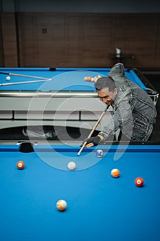 talented pool player poking the white ball