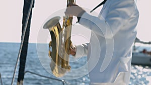 Talented saxophonist performs jazz on saxophone at yacht