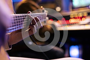 Talented singer playing new accords on electro acoustic guitar photo