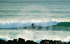 Talented Surfer Surfing on the Big Waves in Pacific Ocean at Hanga Roa Town, Easter Island, Chile