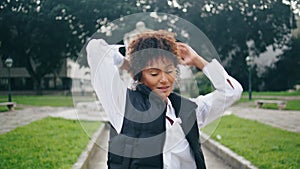 Talented woman performer dancing in park practicing modern freestyle close up.