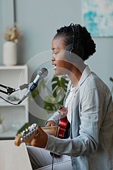 Talented Young Woman Singing to Microphone